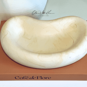 A white bowl sitting on top of a brown table.