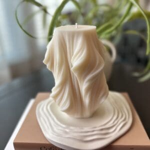 A candle that is sitting on top of a table.