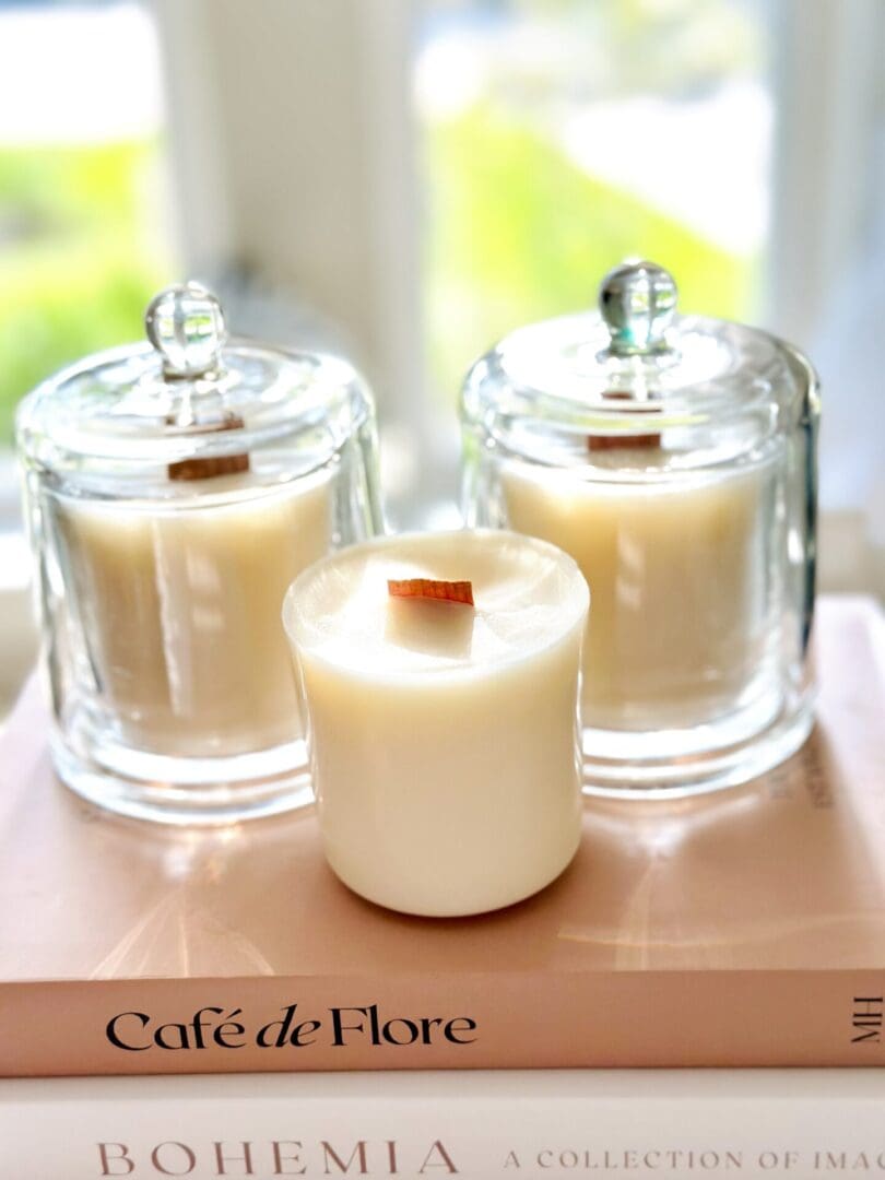 Candles on books in natural light.